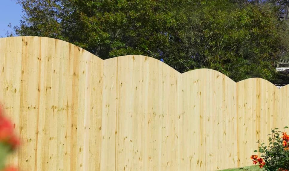 Completed black metal fence enclosing a landscaped yard