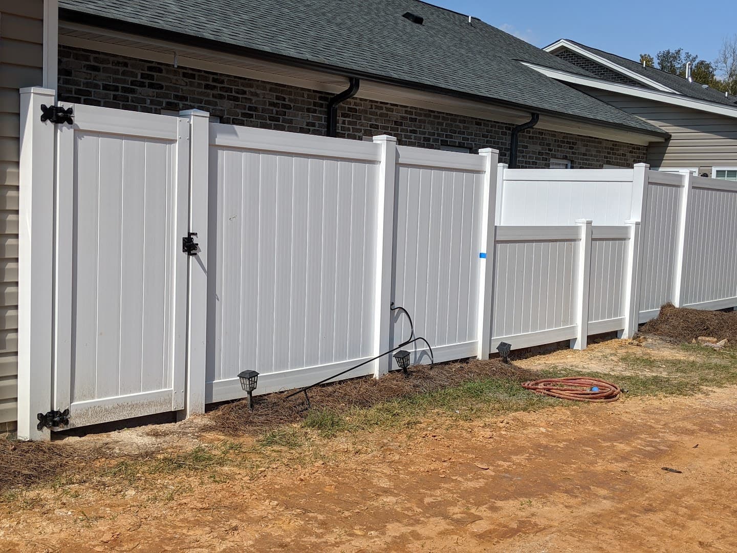 White vinyl privacy fence with a matching gate in High Point, North Carolina