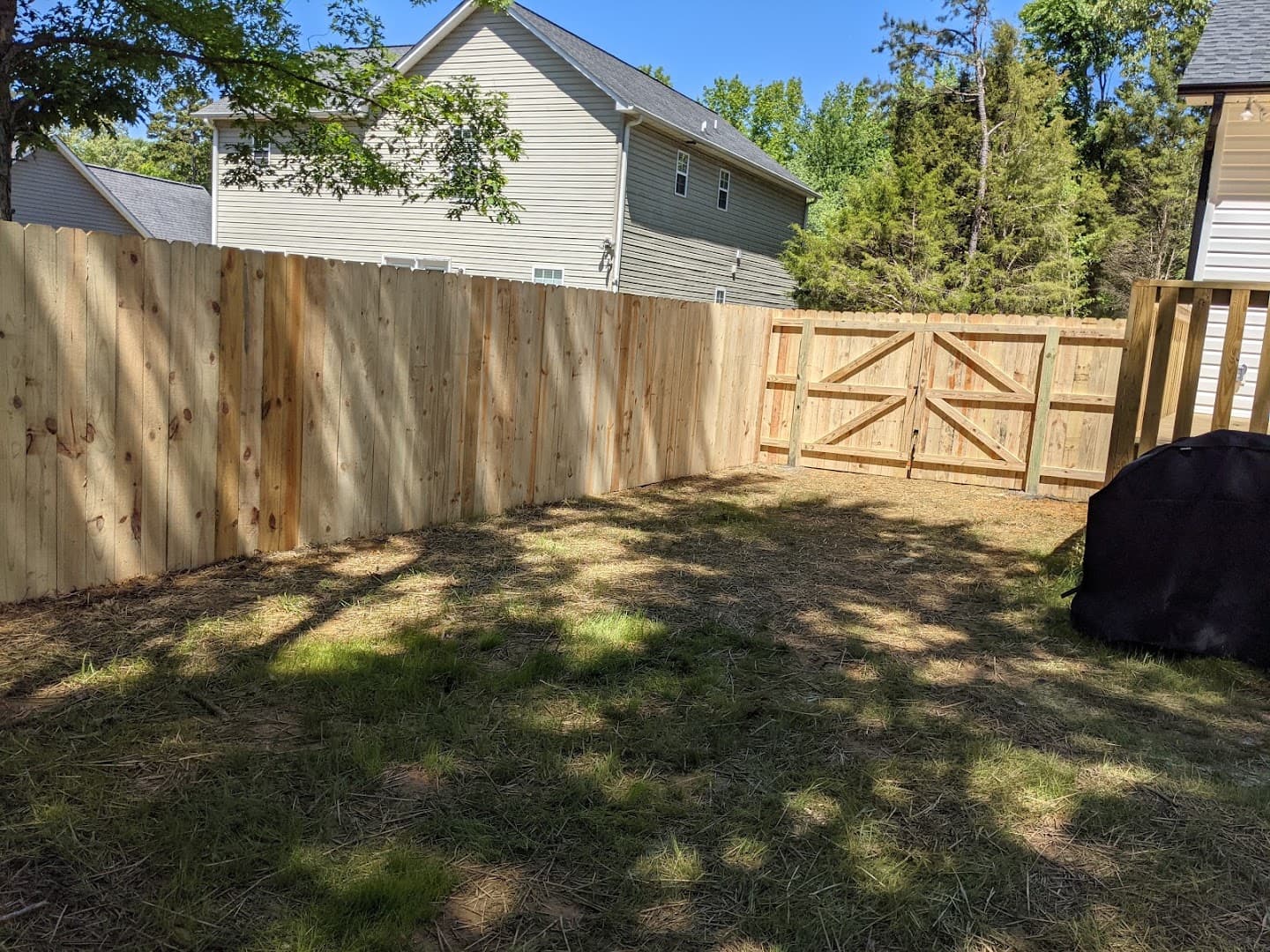 New wood privacy fence with double driveway gates in Thomasville, North Carolina