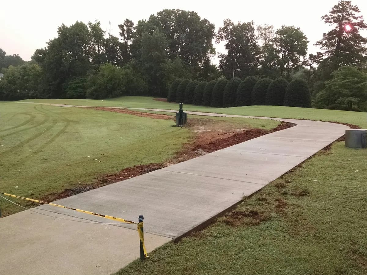 Finished commercial concrete cart path across a Piedmont Triad golf property