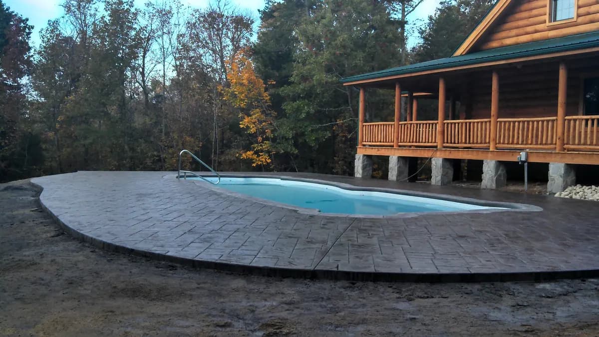 Stamped cobblestone pool deck at a log home, from the 2012 archive