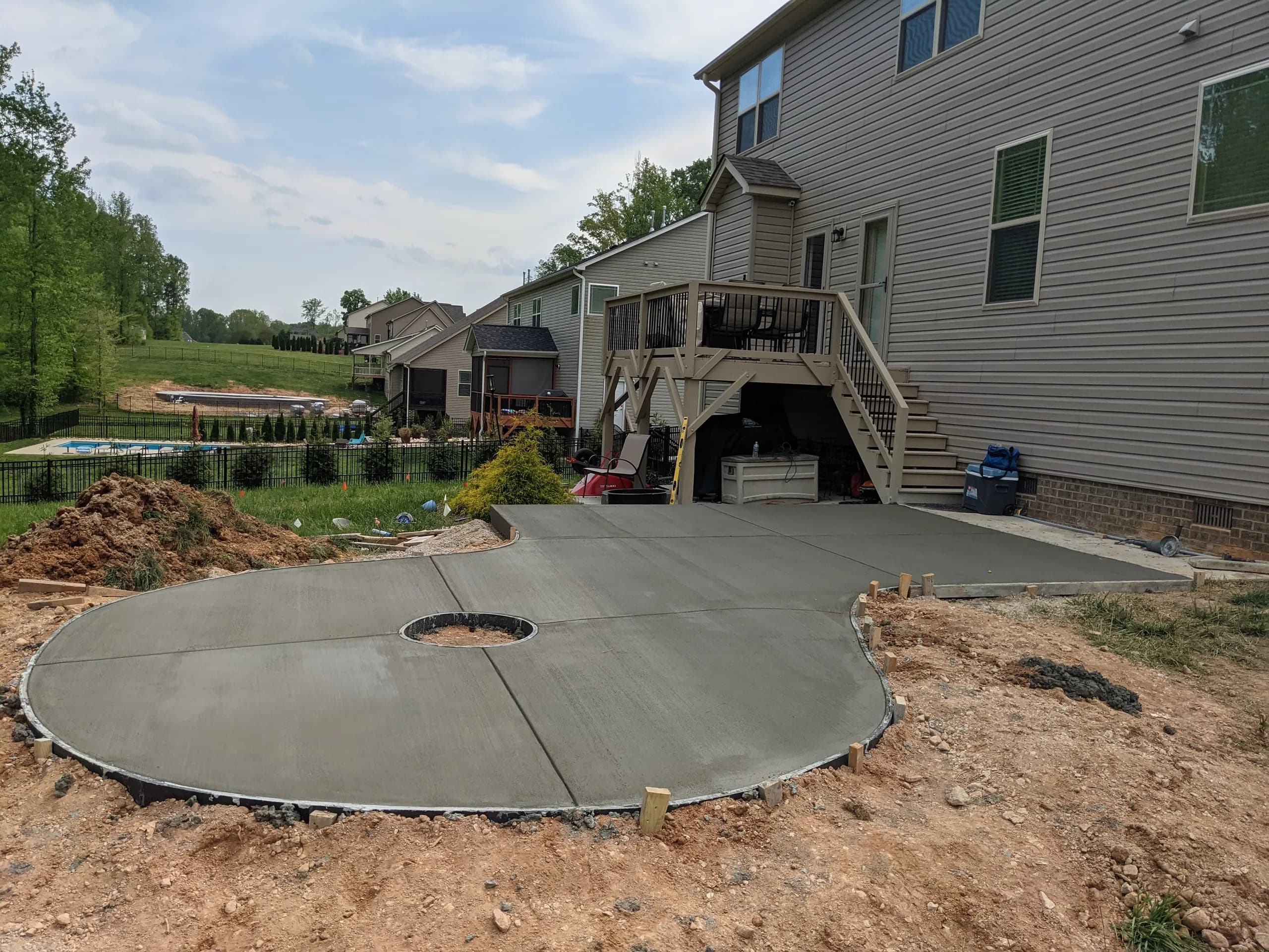 Curved concrete patio with fire-pit blockout, freshly finished