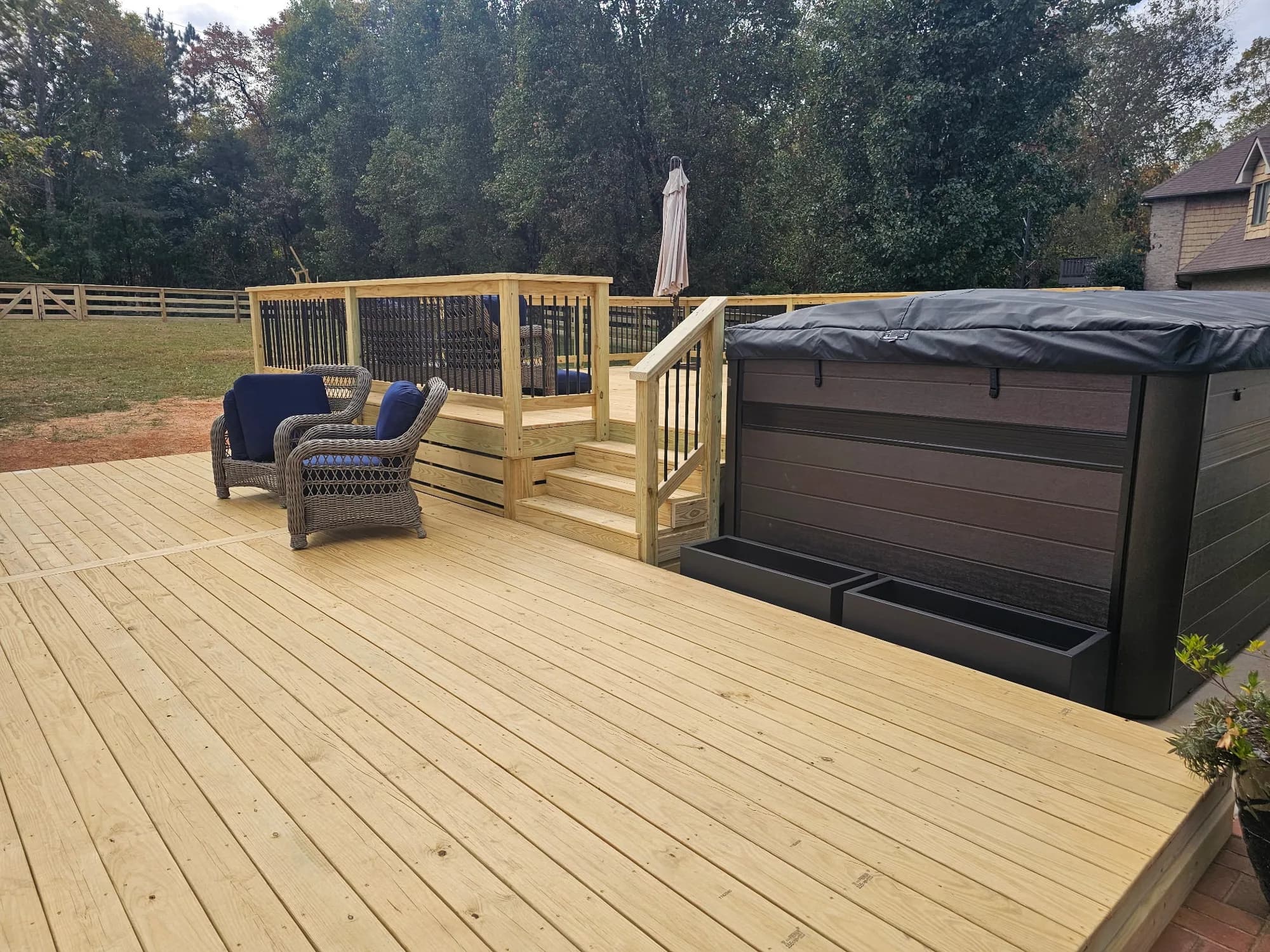 Completed multi-level wood deck built around a hot tub