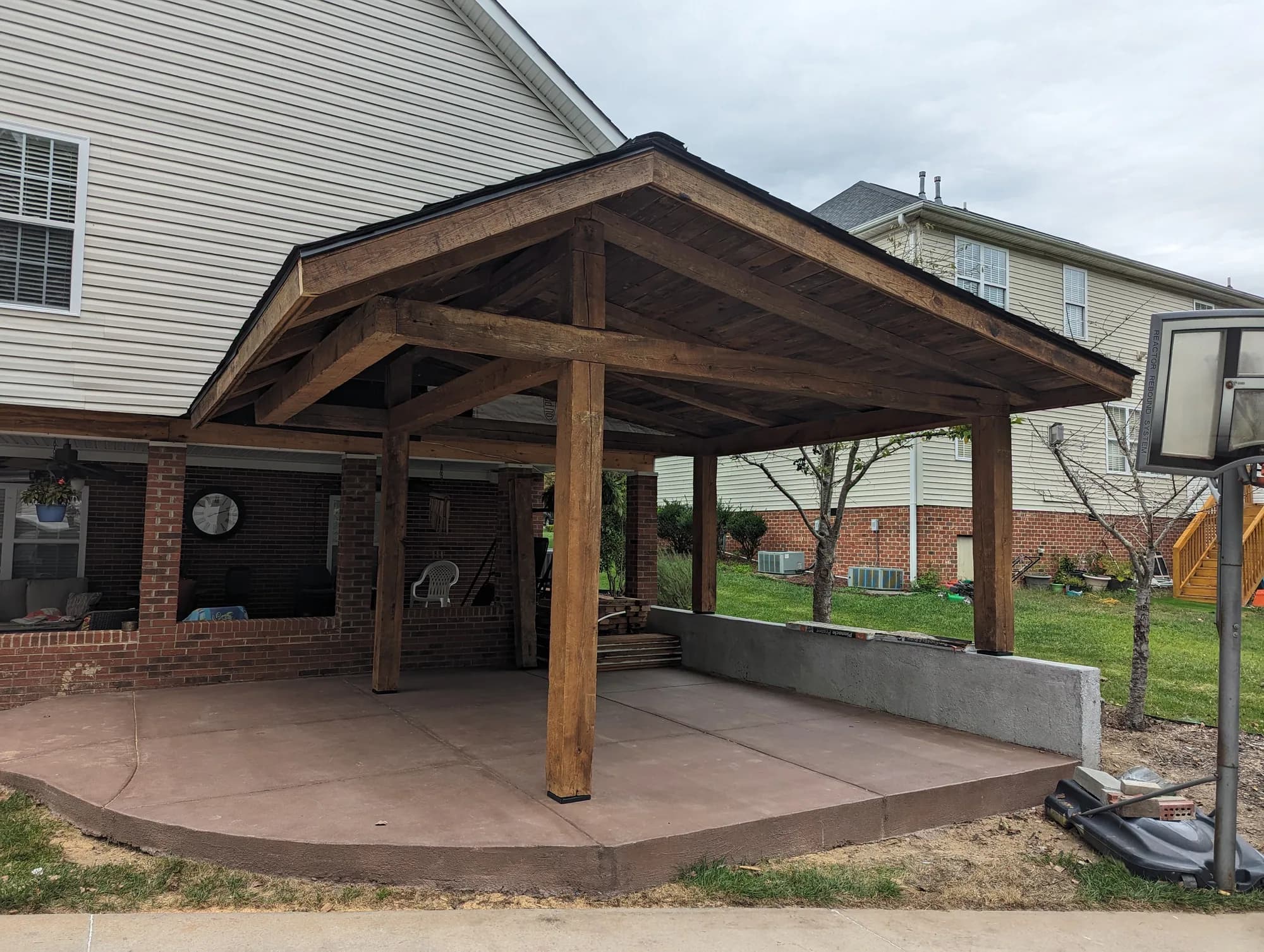 Finished timber pavilion covering a stamped concrete patio