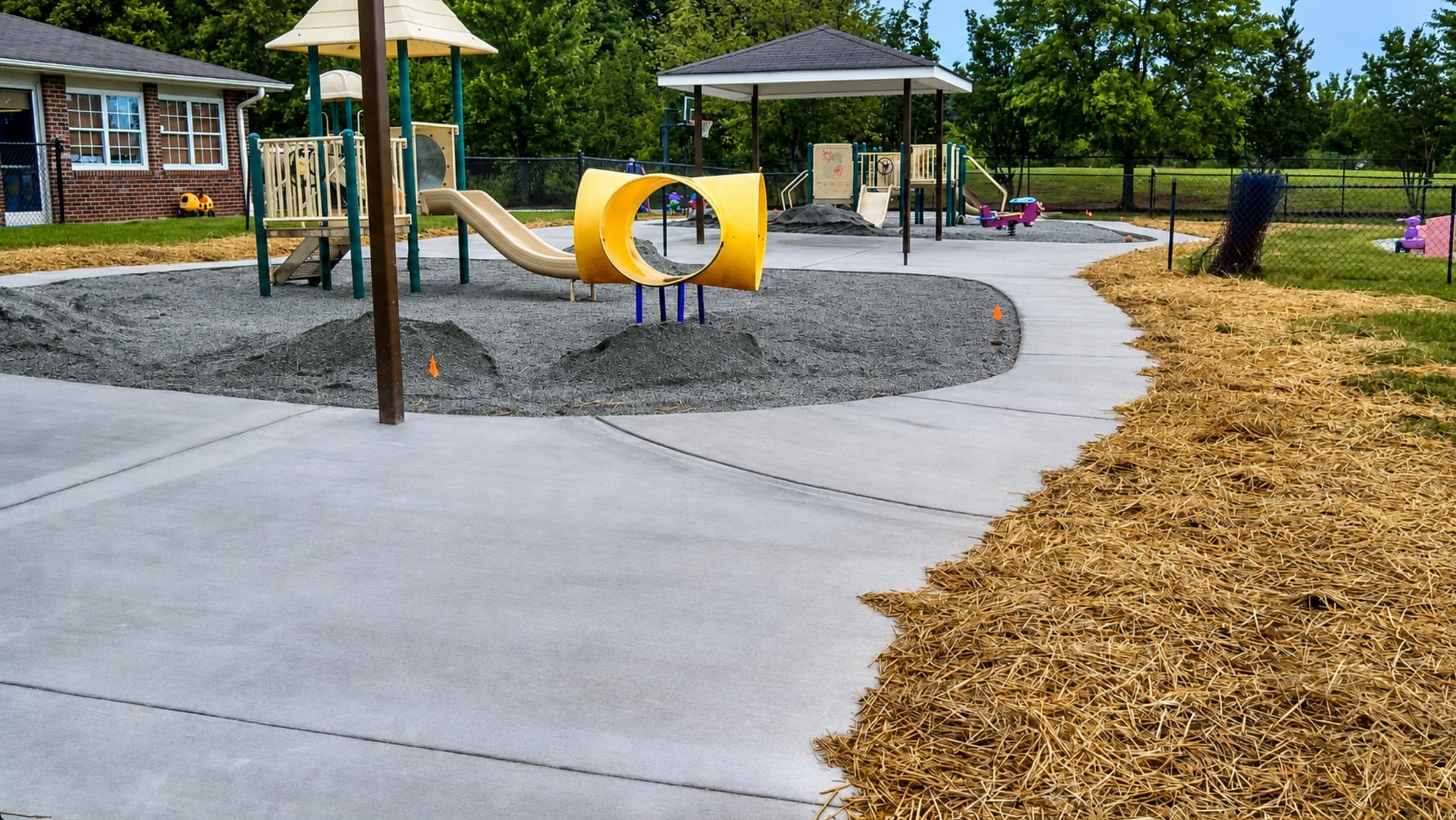 Finished commercial concrete paths around a Piedmont Triad playground