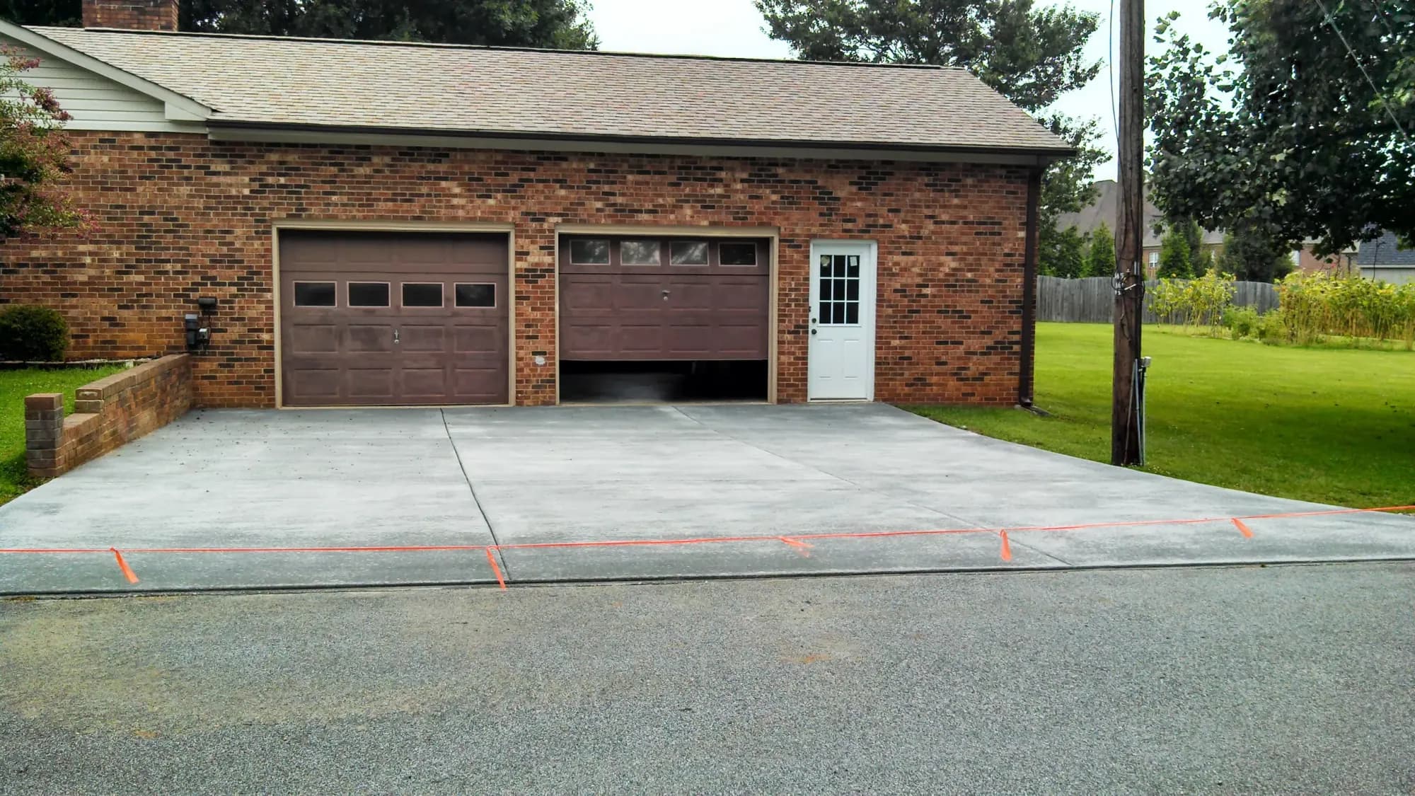 Completed broom-finished concrete driveway in Summerfield, NC