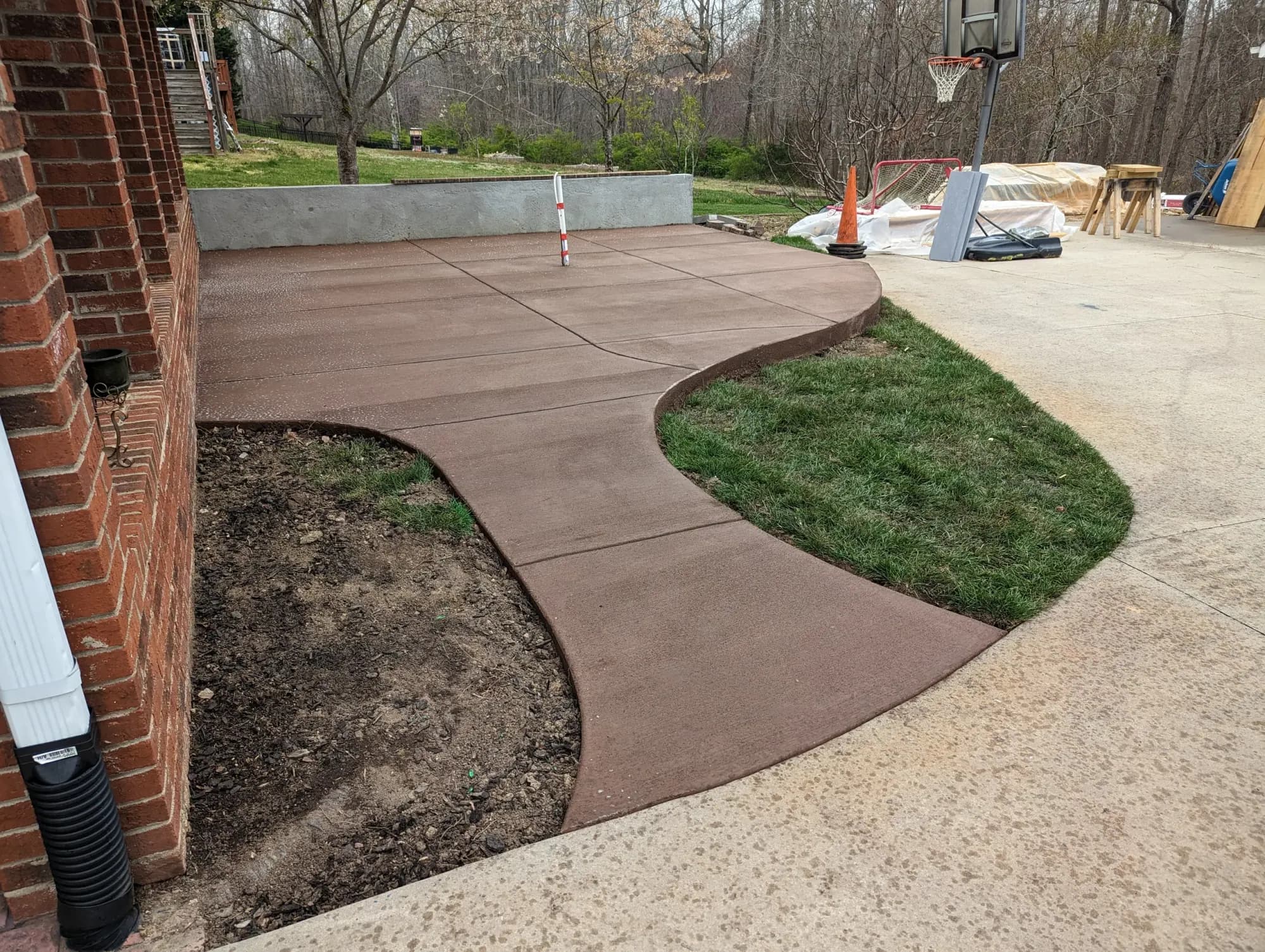 Concrete outdoor-kitchen pad and formed wall with a broom finish in High Point, NC
