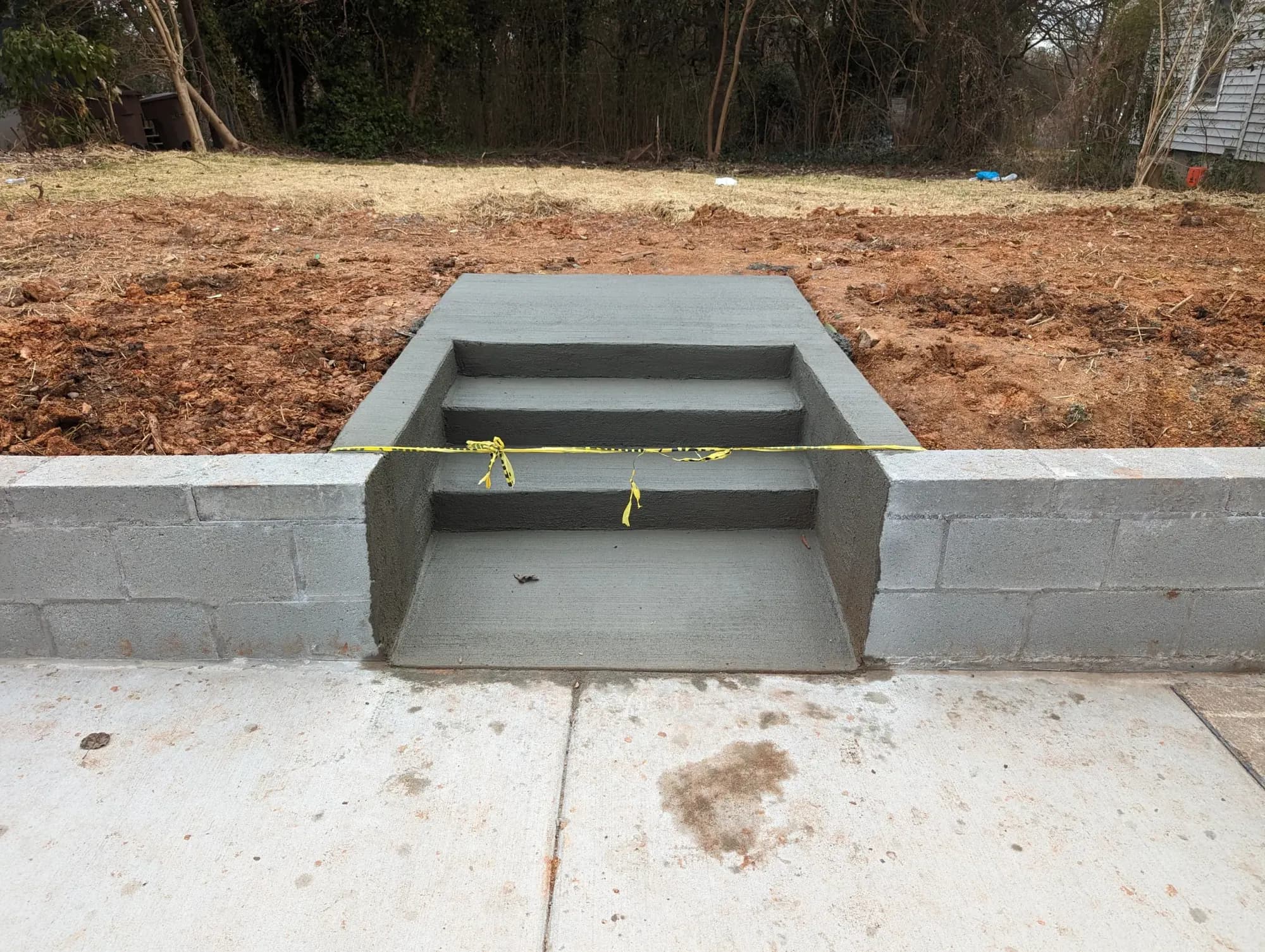New concrete steps with a landing and a block wall in Greensboro, NC