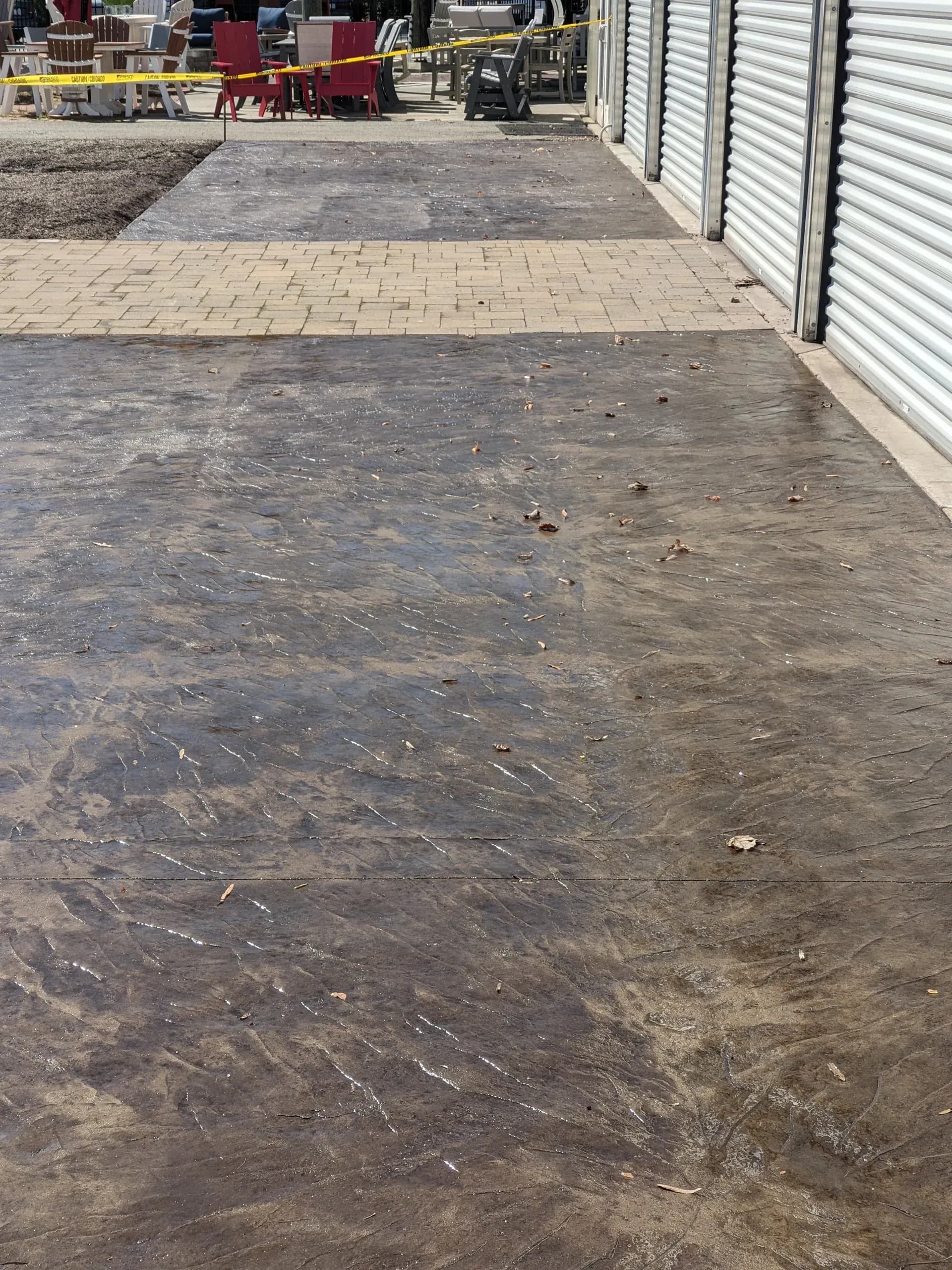 Italian slate stamped concrete staging area in buff with walnut release at Casual Furniture World, Greensboro, NC