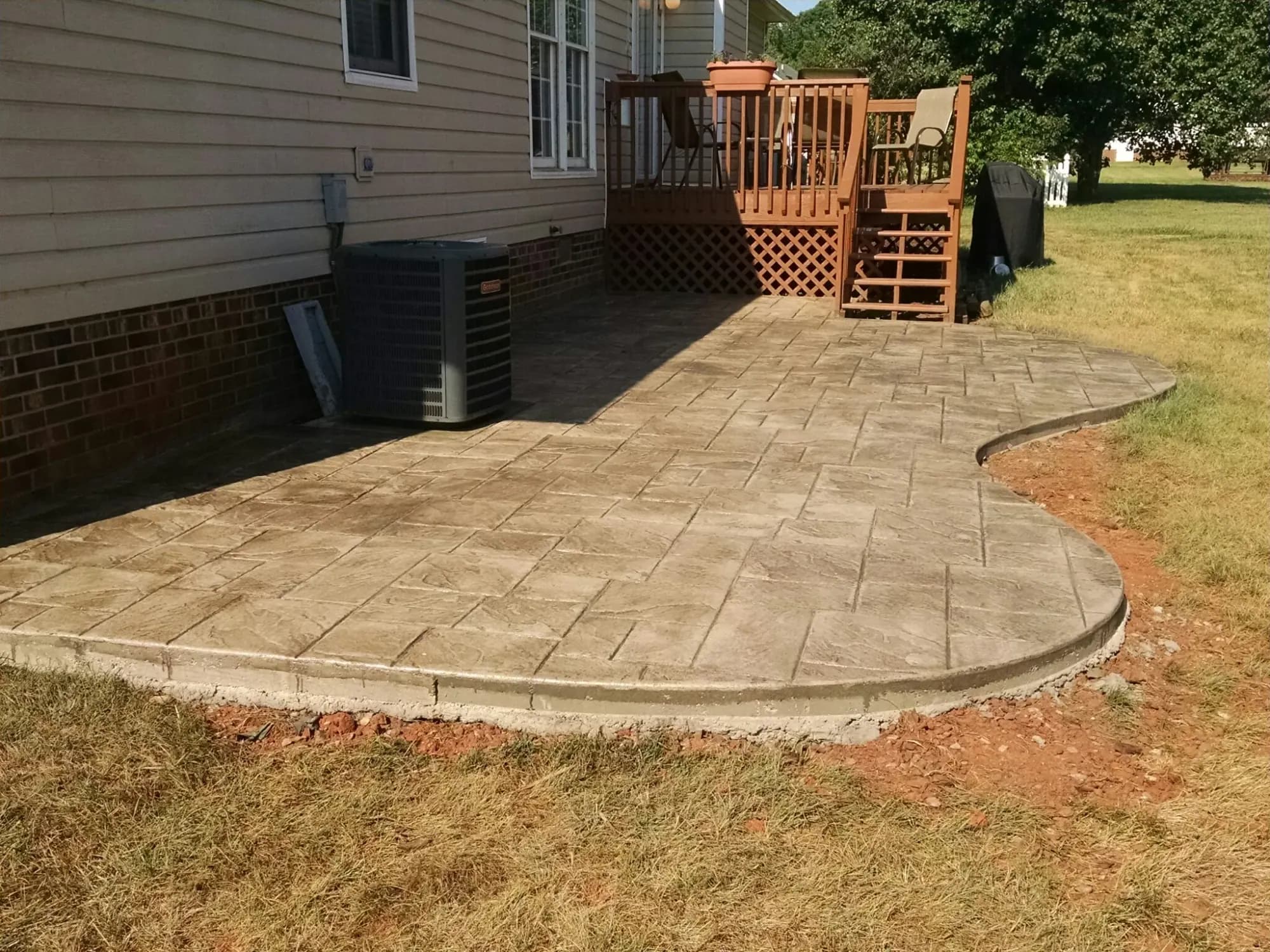 Large ashlar slate stamped concrete patio in buff with walnut release, Greensboro, NC
