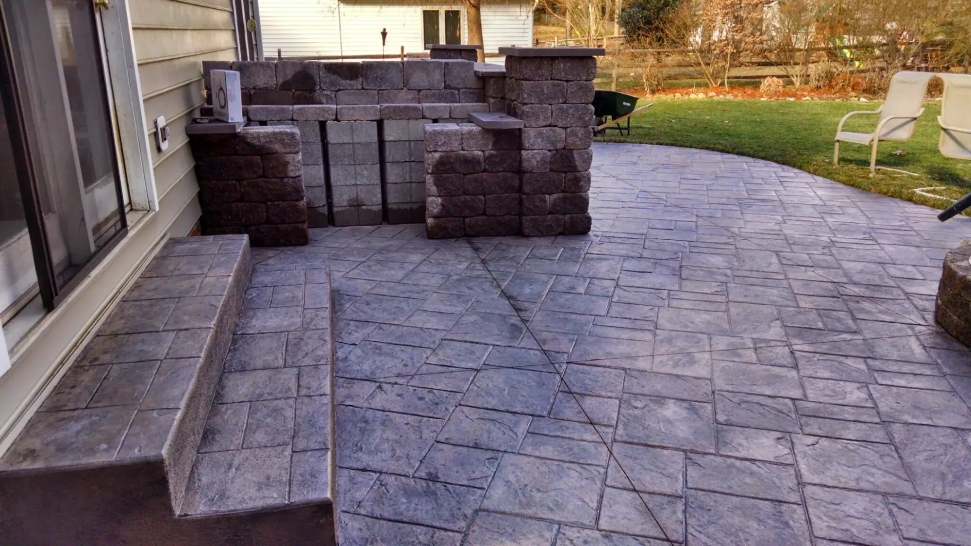 Small ashlar slate stamped concrete patio with steps in sand with dark gray release, Burlington, NC