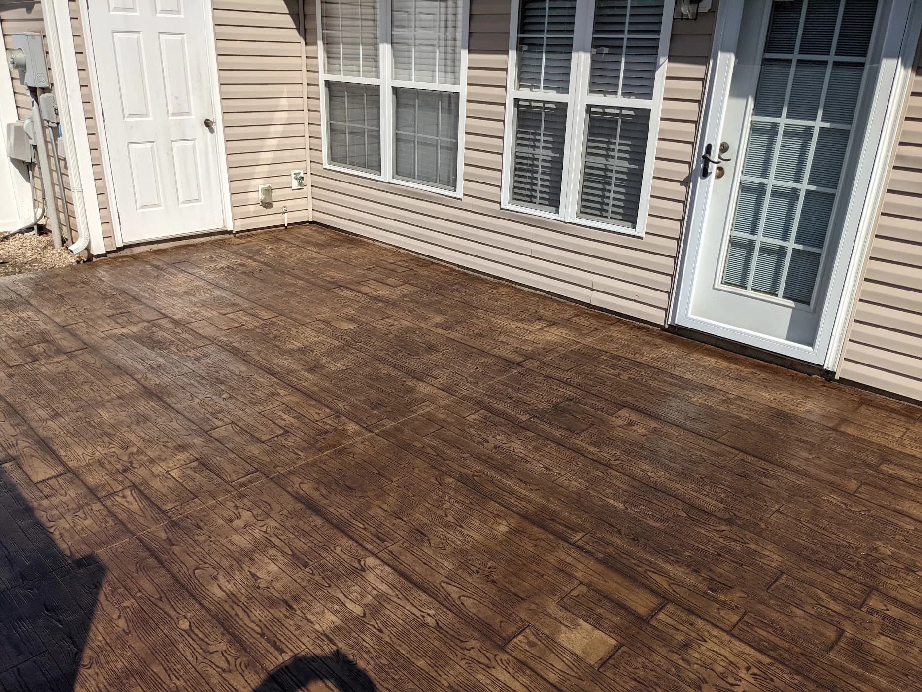 Wood plank stamped concrete patio by Page Concrete in Archdale, NC