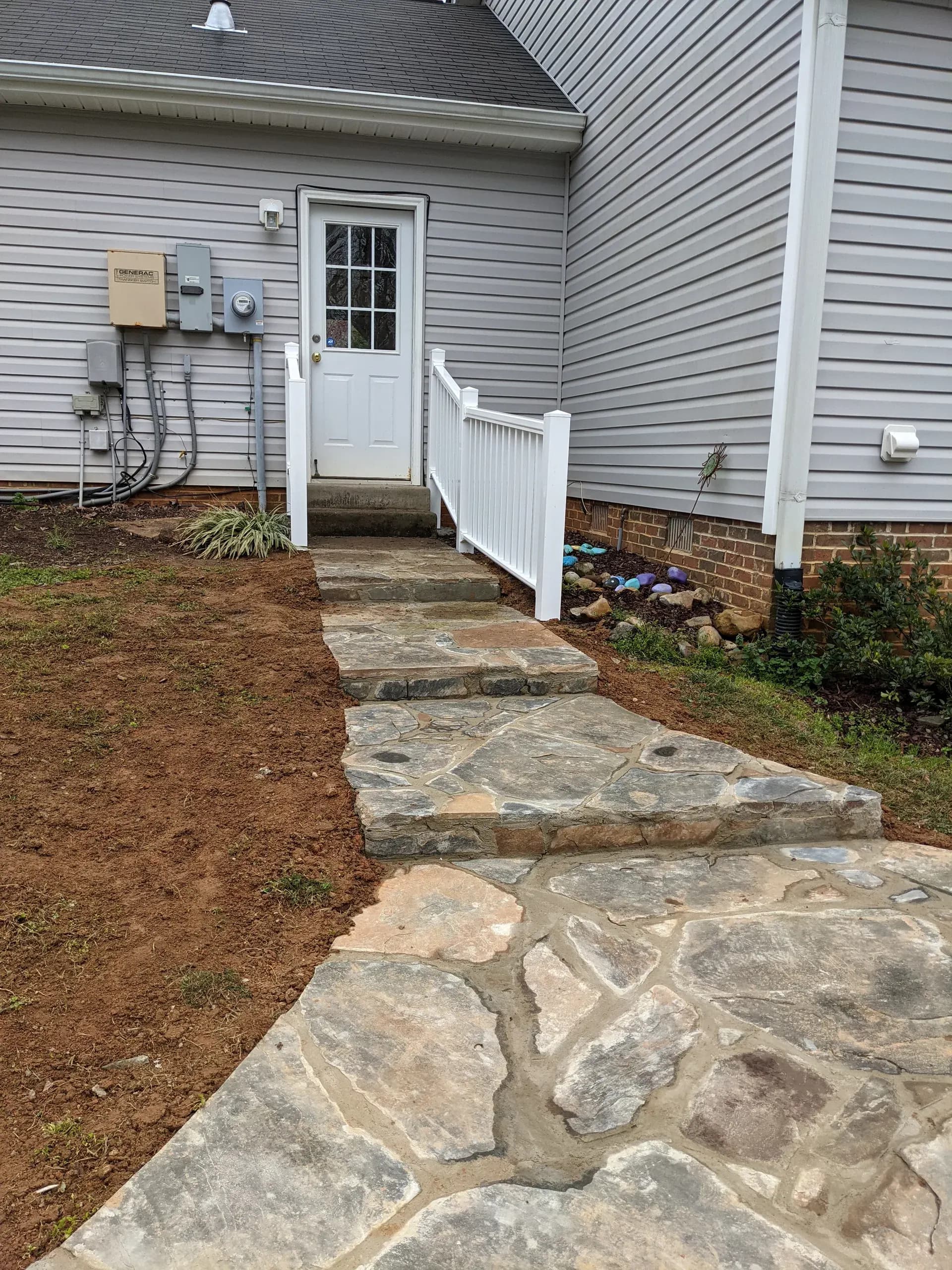 Finished stone walkway with graduated concrete steps in Stokesdale, NC